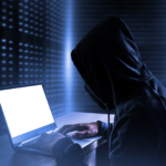 Image of a man using a computer system trying to hack into a small business account; the credit card data is protected because the business has PCI compliance