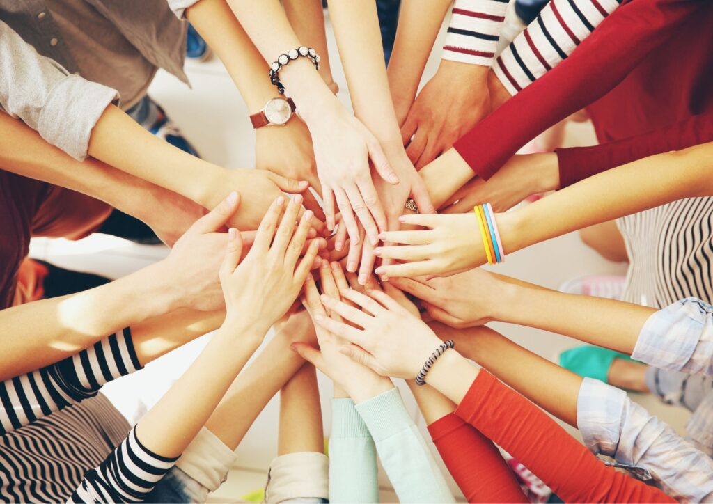 Image of one of our fundraising ideas with people's hands coming together during a Giving Tuesday fundraising event.