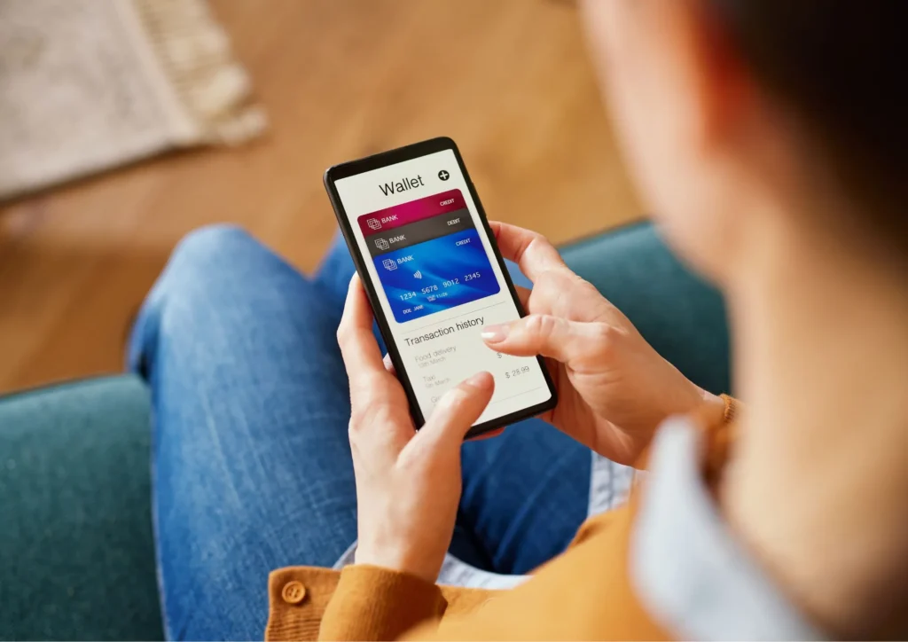 Image of a woman using her mobile wallet to make a mobile payment on her cell phone.
