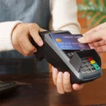 Image of a customer making a card payment with a credit card reader